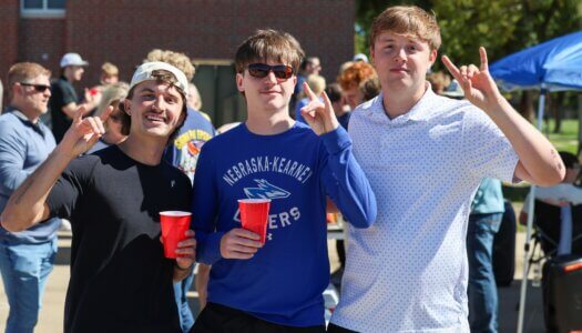 Students throw their Lopes at the tailgate.