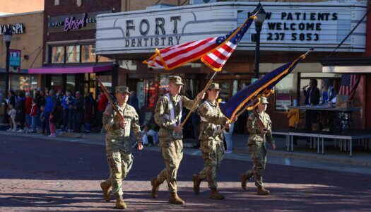 UNK ROTC carry flags in the parade.