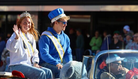 Last year's queen and king Jena Rauert and Sam Schroeder ride in the parade.
