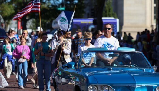 UNK Athletics Hall of Famer Bronson Bosshamer and his son rides in the parade.
