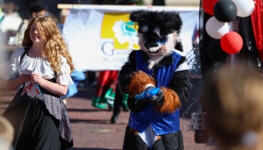 Parade participants hand out candy.