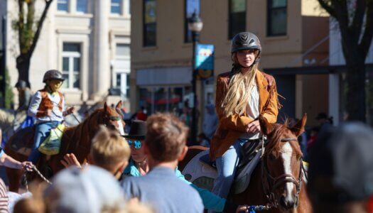 A girl rides horseback in the parade.