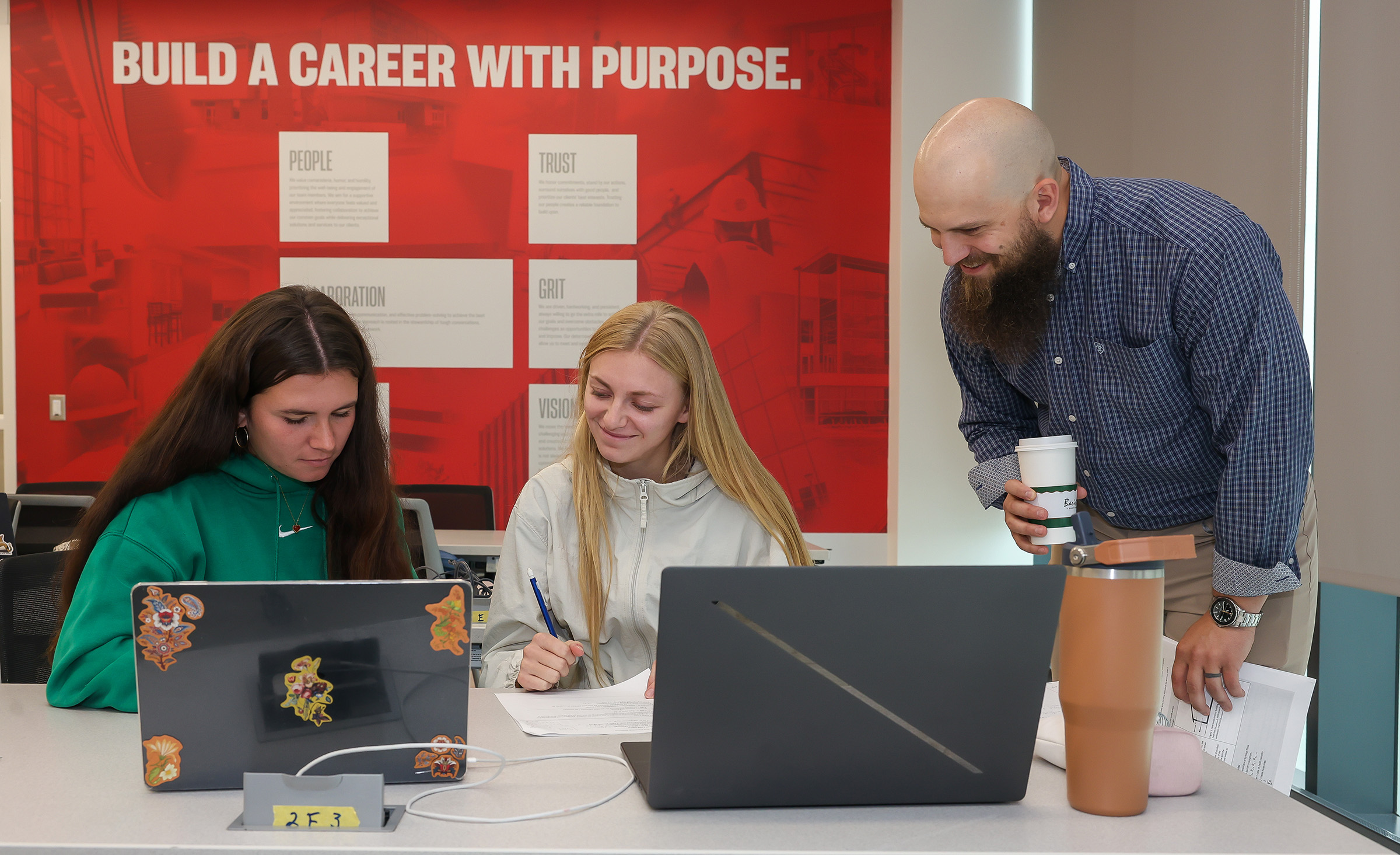 JD Stone works with students in a classroom.