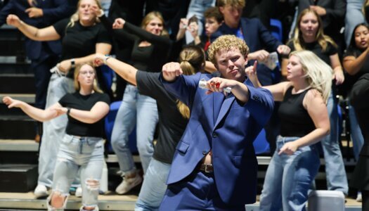 Students dance in the stands.