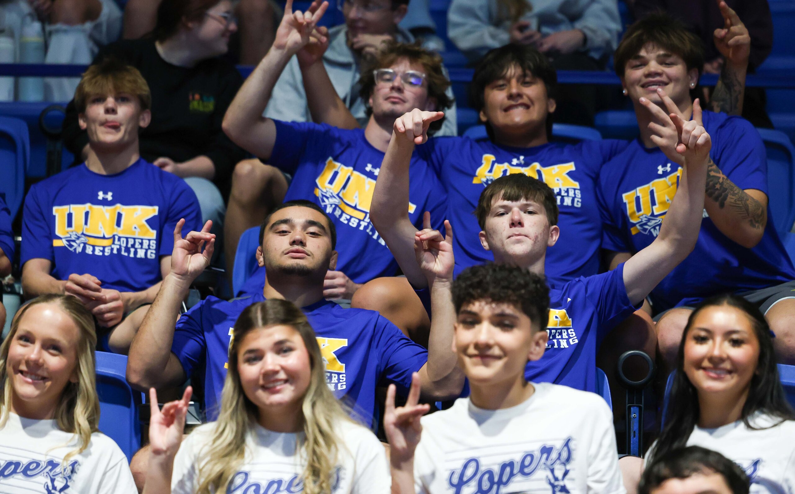 UNK cheer and UNK wrestlers throw their Lopes.