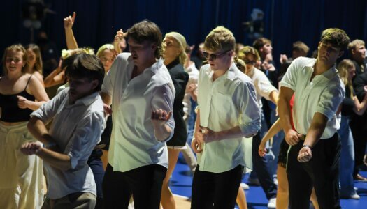 Students dance on the gym floor.