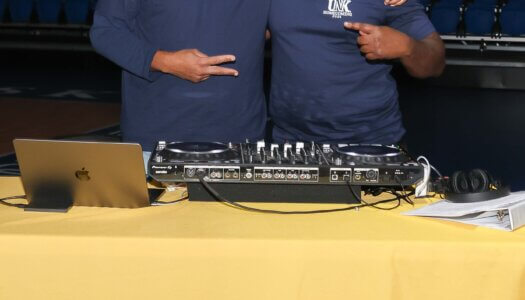 The DJ and announcer pose for a photo.