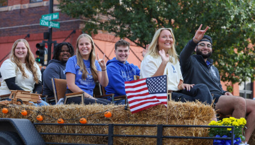 Sydney Owen and other 2024 royalty finalists participate in the UNK homecoming parade.