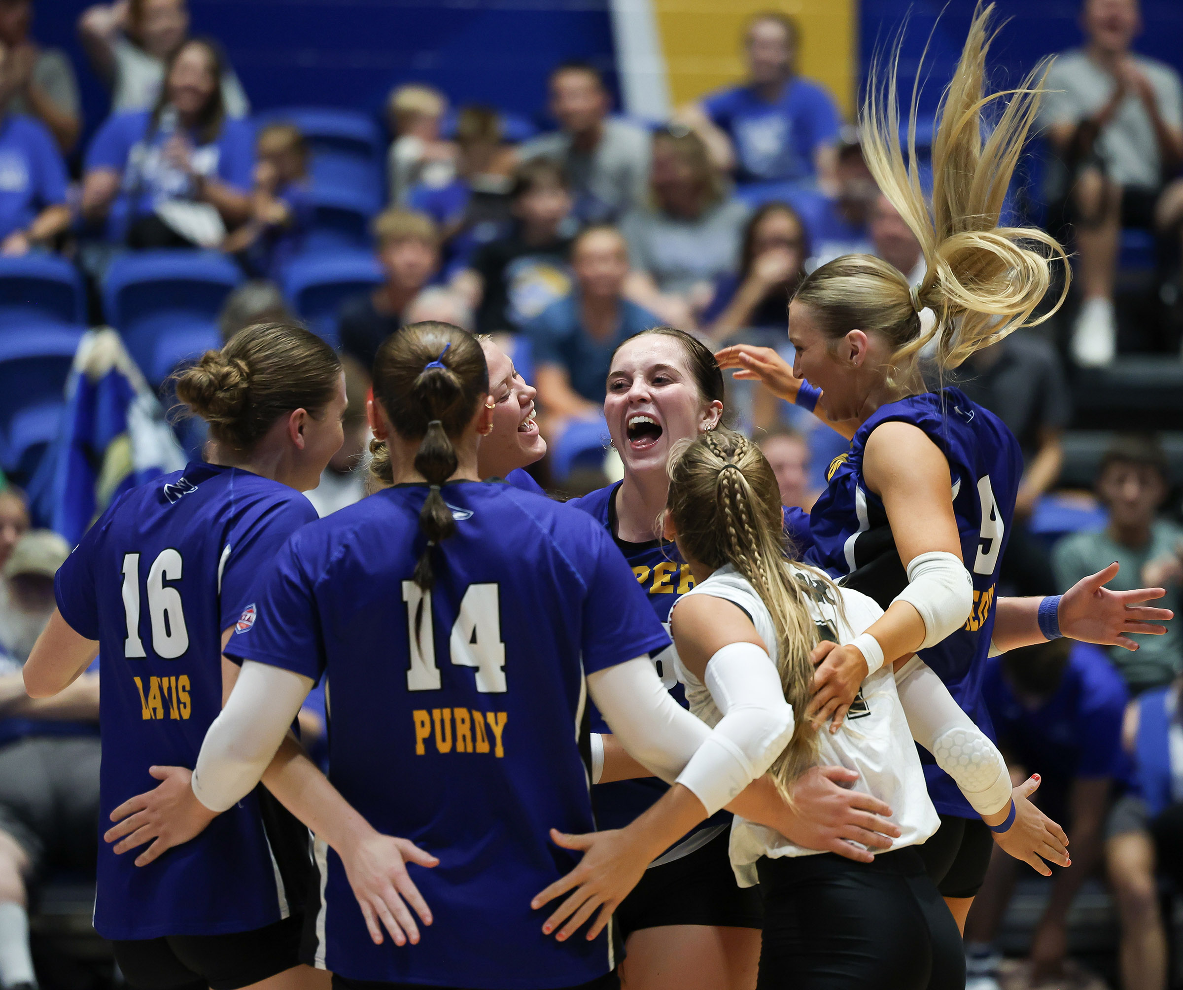 Grace Schmedding celebrates with her UNK teammates.
